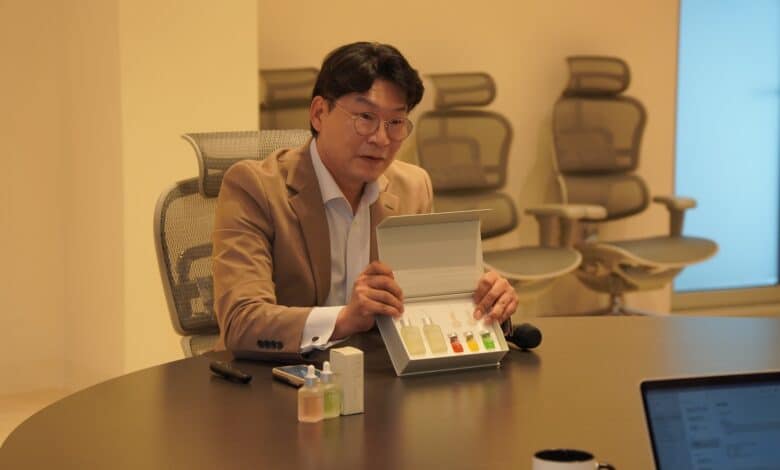 a man sitting at a table with a box of vials